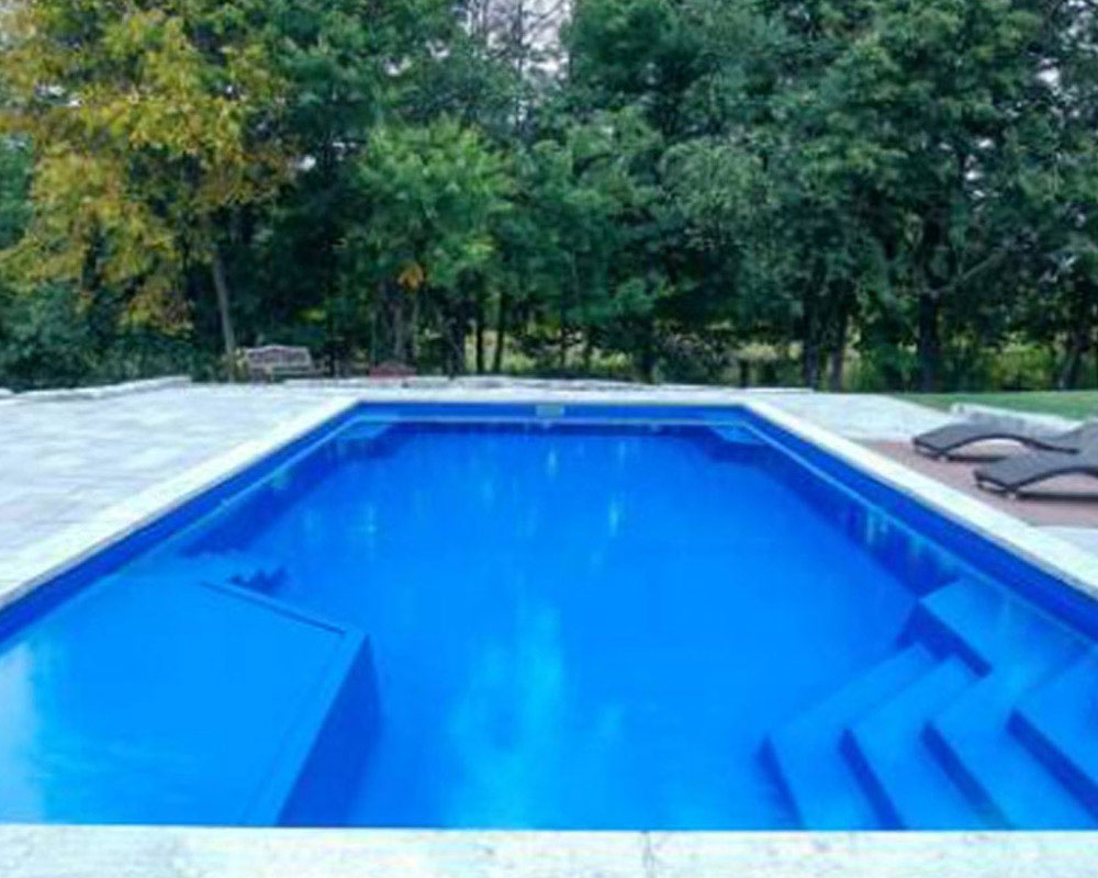 Whitsunday Lounger fiberglass pool with fire pit and retaining wall Ridgeland MS